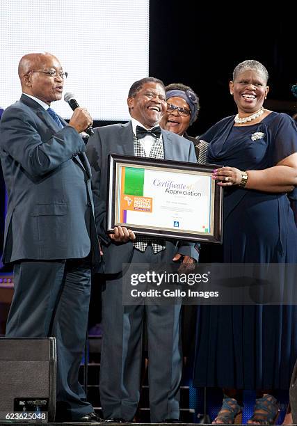 President Jacob Zuma and Ethekwini mayor Zandile Gumede honour Ladysmith Black Mambazos retired lead vocalist; Joseph Shabalala with a certificate of...