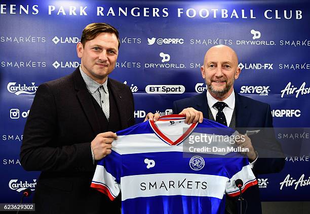 Newly appointed Queens Park Rangers manager Ian Holloway poses with first team coach Marc Bircham during a press conference at Loftus Road on...