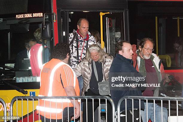 Tourists and locals disembark a bus at the Horncastle Arena in Christchurch after being evacuated by the HMNZS Canterbury Naval ship from Kaikoura on...