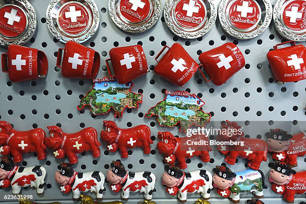 Novelty Swiss cow and cowbell fridge magnets hang on display inside a souvenir shop in Lugano, Switzerland, on Tuesday, Nov. 15, 2016. While the...