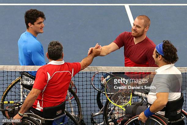 Gustavo Fernandez of Argentina and Maikel Scheffers of the Netherlands come to the net after winning their men's doubles match against Umberto...