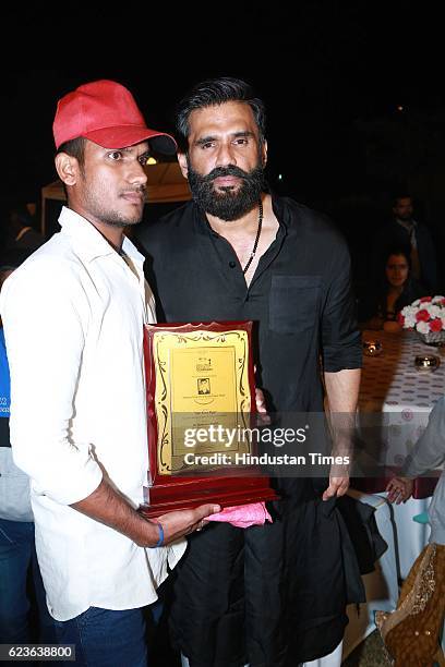 Bollywood actor Suniel Shetty with a family member of URI attack salutes Nation's Guardians during an event organized by Heera Group of Companies &...