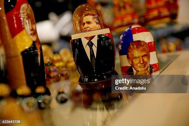 Painted Matryoshka dolls, or Russian nesting dolls, bearing the faces of President-elect Donald Trump and president Barack Obama are offered in a...