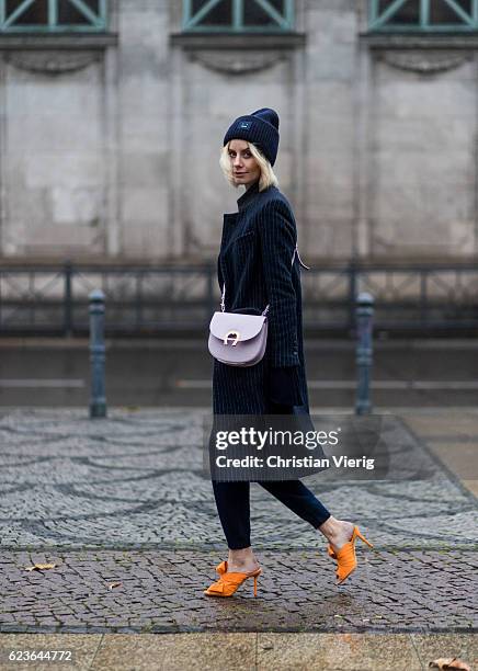 Lisa Hahnbueck wearing navy stripped Asos Pinstripe Coat, a black H&M Trend Rip Knit with XXL Sleeves / Big Sleeves, navy Allude Cashmere Jogging...