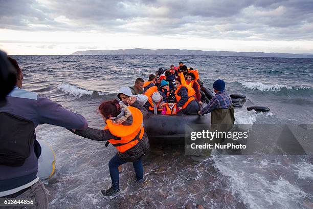 Syrian and many Afghan migrants / refugees arrive from Turkey on boat through sea with cold water near Molyvos, Lesbos on overloaded dinghies....