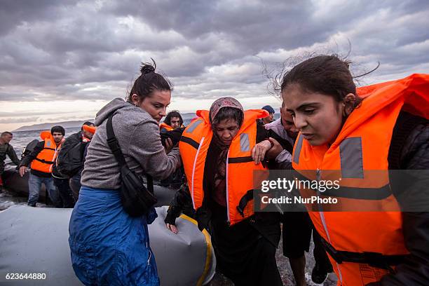 Syrian and many Afghan migrants / refugees arrive from Turkey on boat through sea with cold water near Molyvos, Lesbos on overloaded dinghies....