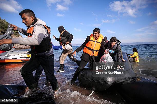 Syrian and many Afghan migrants / refugees arrive from Turkey on boat through sea with cold water near Molyvos, Lesbos on overloaded dinghies....