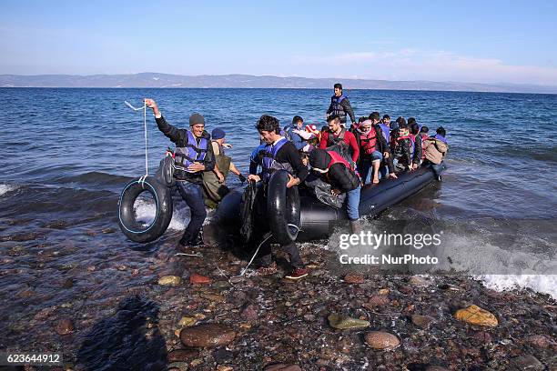 Syrian and many Afghan migrants / refugees arrive from Turkey on boat through sea with cold water near Molyvos, Lesbos on overloaded dinghies....