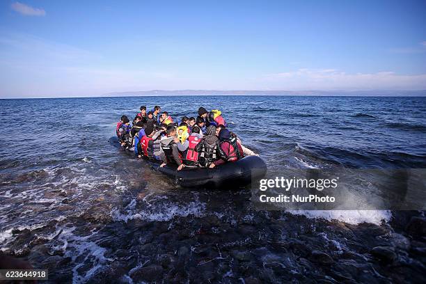 Syrian and many Afghan migrants / refugees arrive from Turkey on boat through sea with cold water near Molyvos, Lesbos on overloaded dinghies....