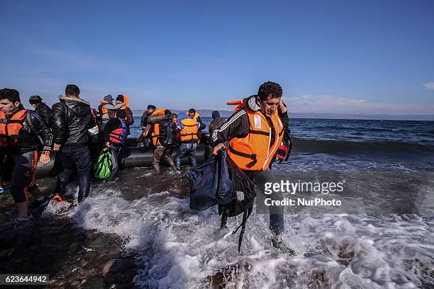 Syrian and many Afghan migrants / refugees arrive from Turkey on boat through sea with cold water near Molyvos, Lesbos on overloaded dinghies....