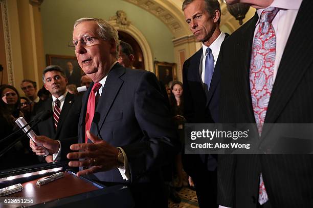 Senate Majority Leader Sen. Mitch McConnell speaks to members of the media flanked by Sen. Cory Gardner and Sen. John Thune during a news briefing...