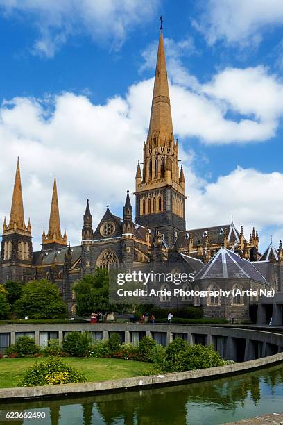 view of the gothic revival central tower of st patrick's cathedral, melbourne, victoria, australia - saint patrick stock pictures, royalty-free photos & images