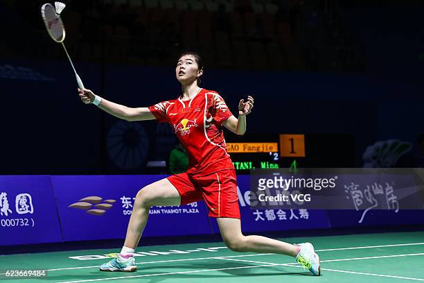 Gao Fangjie of China returns to Mitani Minatsu of Japan during women's singles first round match on day two of BWF Thaihot China Open 2016 at Haixia...