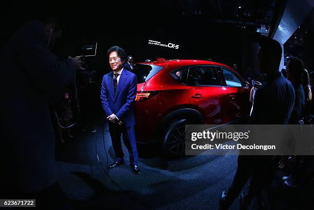 Masa Moro, President and CEO, Mazda North American Operations, speaks with a member of the media after the Mazda press conference event at the L.A....