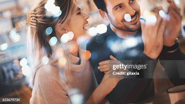 couple having fun at coffee house. - street style couple stock pictures, royalty-free photos & images