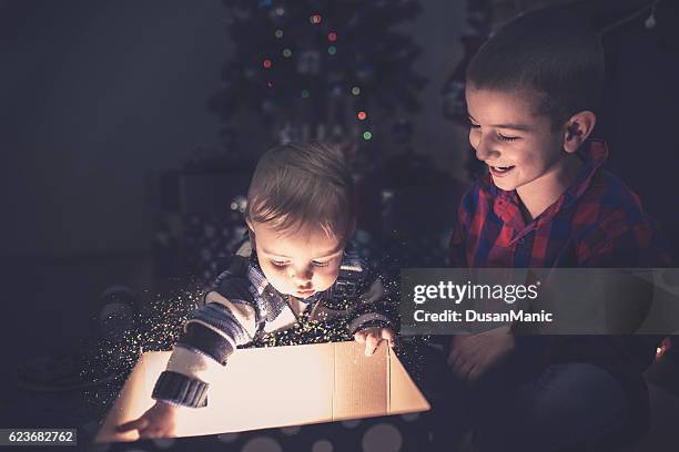 two happy boy open christmas gift-box - december 6 stock pictures, royalty-free photos & images