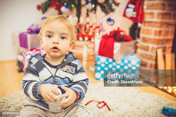 adorable ten month old baby boy in a christmas setting - face surprise heat stock pictures, royalty-free photos & images