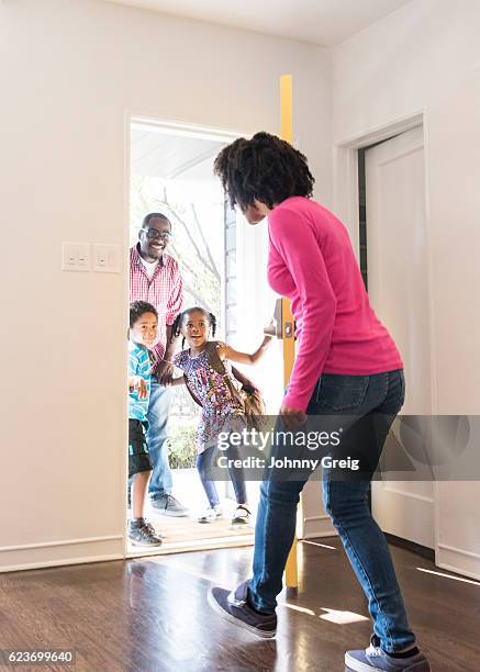 young african american woman opening door to family - man opening door woman bildbanksfoton och bilder