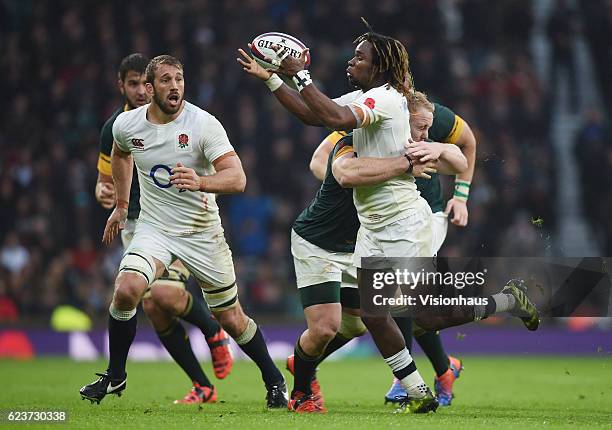 Marland Yarde of England is tackled by Vincent Koch of South Africa during the Old Mutual Wealth Series match between England and South Africa at...