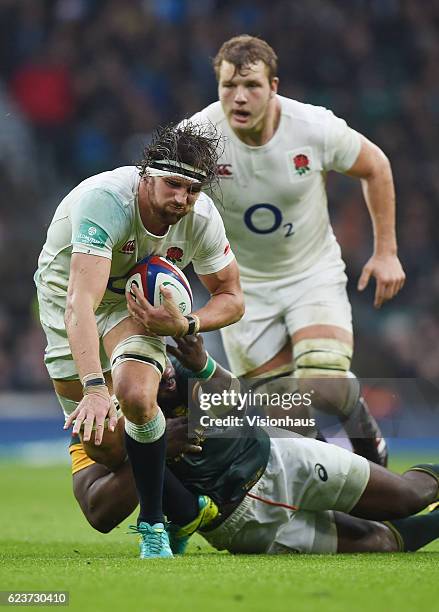 Tom Wood of England is tackled by Tendai Mtawarira of South Africa during the Old Mutual Wealth Series match between England and South Africa at...