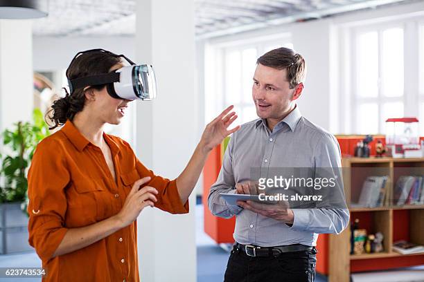 colleagues testing out virtual reality software - virtual reality business stock pictures, royalty-free photos & images