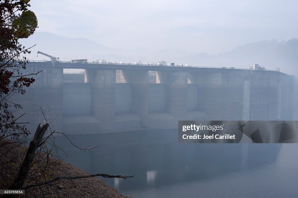 Forest fire smoke and construction equipment at Fontana Dam