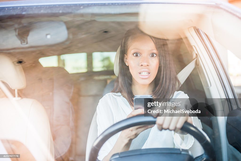 African American Women Surprised Texting In A Car