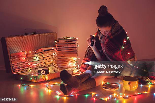 night exciting reading with christmas lights - art christmas stock pictures, royalty-free photos & images