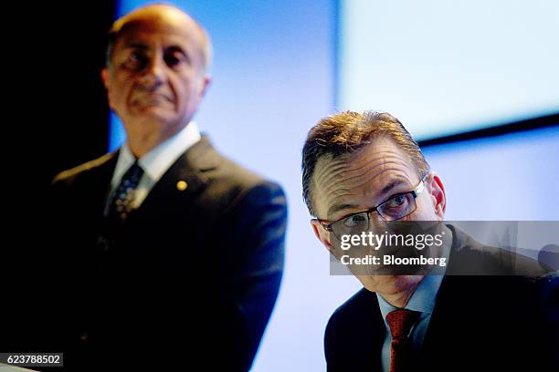 Andrew Mackenzie, chief executive officer of BHP Billiton Ltd., right, and Jacques "Jac" Nasser, chairman, look on during the company's annual...