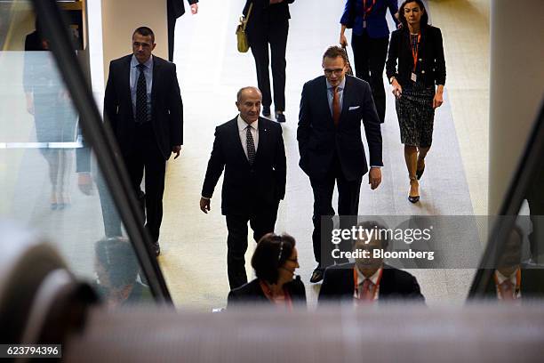 Jacques "Jac" Nasser, chairman of BHP Billiton Ltd., center left, and Andrew Mackenzie, chief executive officer, center right, leave following the...