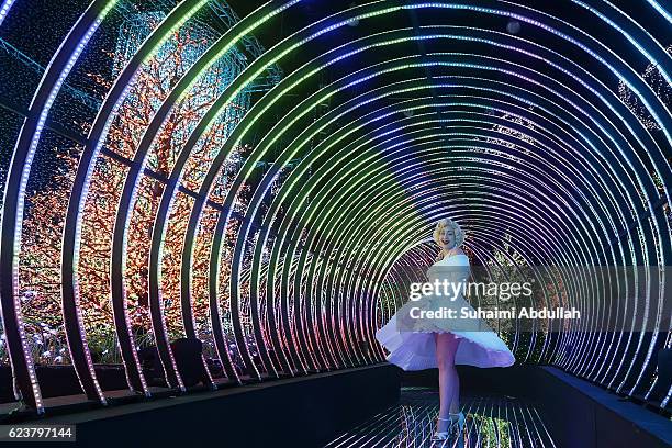 Marilyn Monroe impersonator poses for a photo inside the Rainbow Connection light display during the media preview of Universal Journey, a Santa's...