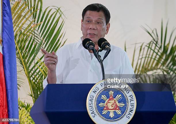 Philippine President Rodrigo Duterte gestures as he delivers a speech, prior to his departure for the APEC summit in Peru, at Davo airport, in...