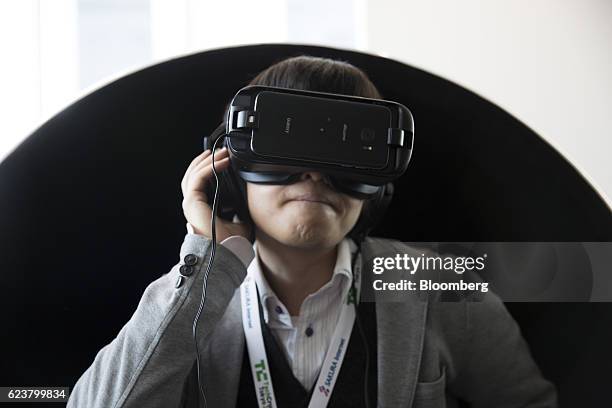 An attendee tries Samsung Electronics Co.'s Gear VR headset at the Tech Crunch Tokyo 2016 in Tokyo, Japan, on Thursday, Nov. 17, 2016. The two-day...