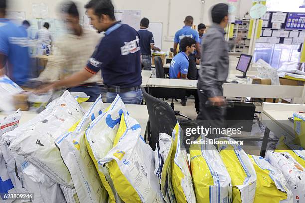 Workers sort packages at a Flipkart Online Services Pvt office in the Jayaprakash Narayan Nagar area of Bengaluru, India, on Wednesday, Oct. 26,...