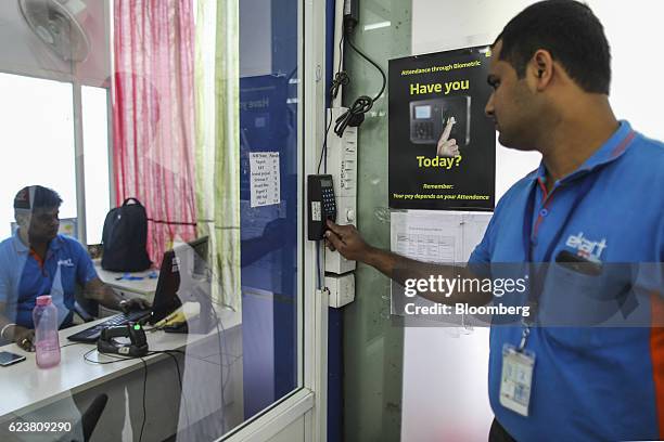 Abdul Saleem, a deliveryman known as a Wishmaster for Flipkart Online Services Pvt's Ekart Logistics service, scans his figerprint at a biometric...