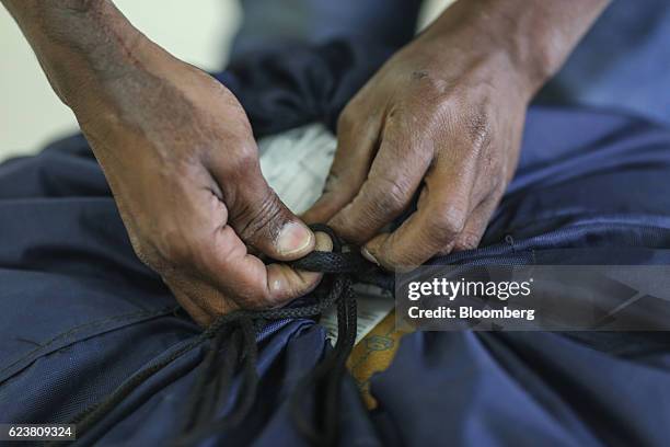 An employee ties a knot on a delivery bag at a Flipkart Online Services Pvt office in the Jayaprakash Narayan Nagar area of Bengaluru, India, on...