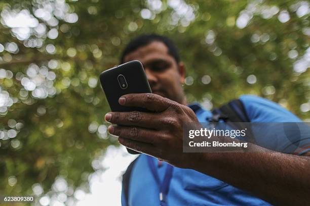 Abdul Saleem, a deliveryman known as a Wishmaster for Flipkart Online Services Pvt's Ekart Logistics service, uses a smartphone while delivering...