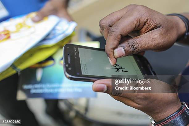 Customer signs an e-signature on a smartphone on receiving a package from Flipkart Online Services Pvt's Ekart Logistics service in Bengaluru, India,...