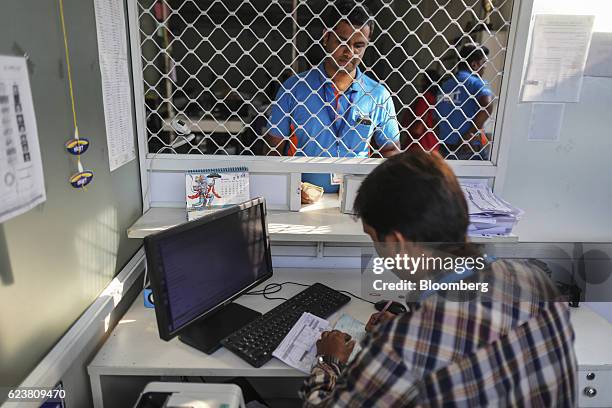 Abdul Saleem, a deliveryman known as a Wishmaster for Flipkart Online Services Pvt's Ekart Logistics service, top, stands at a cash counter inside...