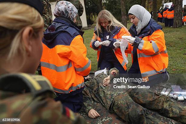 Syrian refugees demonstrate skills they have learned in a first aid training program sponsored by the Bundeswehr for Syrian female refugees during a...