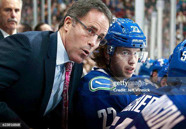 Assistant coach Doug Lidster of the Vancouver Canucks talks to Ben Hutton during their NHL game against the Dallas Stars at Rogers Arena November 13,...