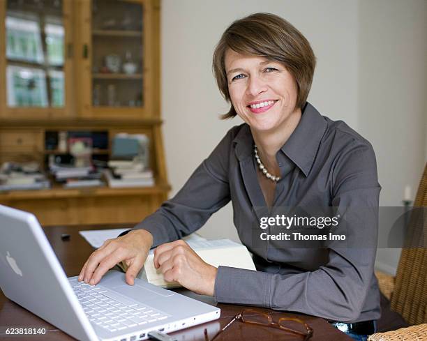 Berlin, Germany Elke Buedenbender works at home on her laptop on August 18, 2009 in Berlin, Germany.