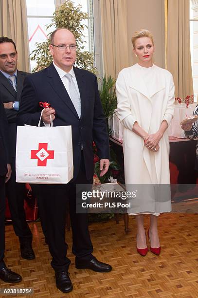 Prince Albert II of Monaco and Princess Charlene of Monaco attend the Parcels Distribution At Monaco Red Cross Headquarters on November 17, 2016 in...