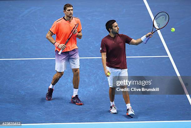 Max Mirnyi of Belarus and Treat Huey of Philippines talk in their men's doubles match against Bob Bryan and Mike Bryan of the United States on day...