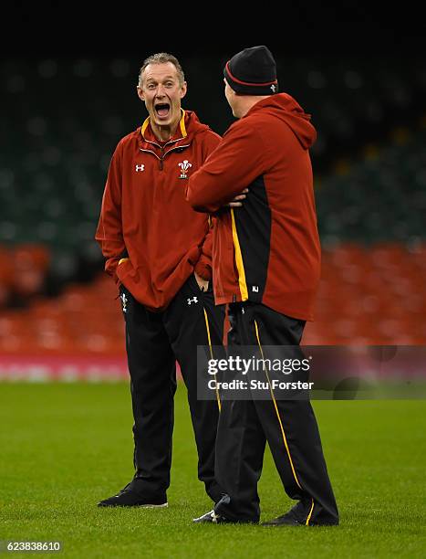 Wales coach Robert Howley shares a joke with Neil Jenkins during Wales training ahead of their match against Japan at the Millennium Stadium on...