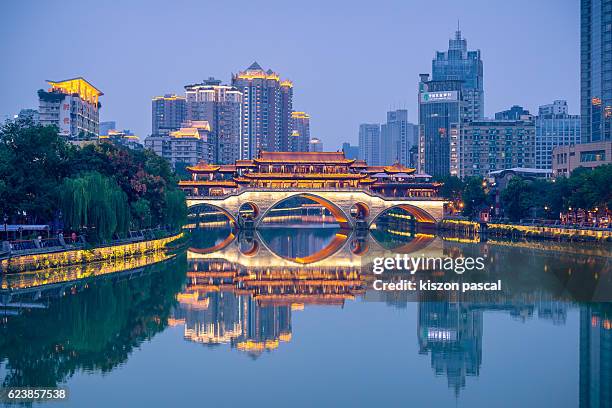 illuminated anshun bridge with reflection, chengdu - chengdu stock pictures, royalty-free photos & images