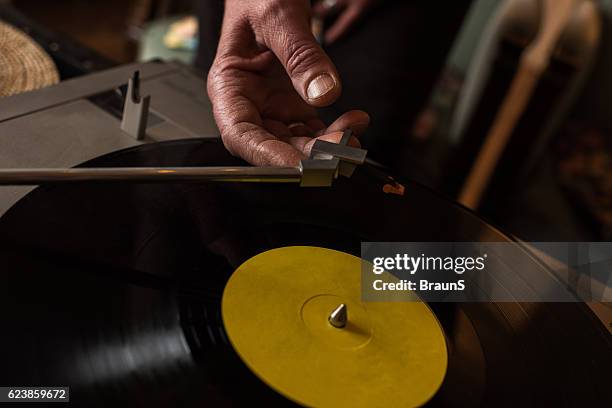 close up of playing music on a turntable. - hand stylus stock pictures, royalty-free photos & images