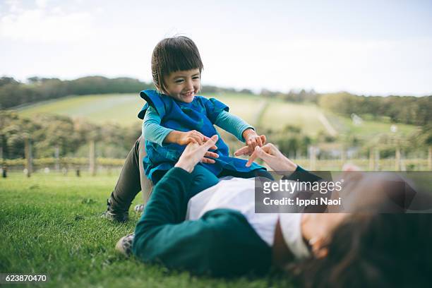 mother and child playing on grass - australian vinyards stock pictures, royalty-free photos & images