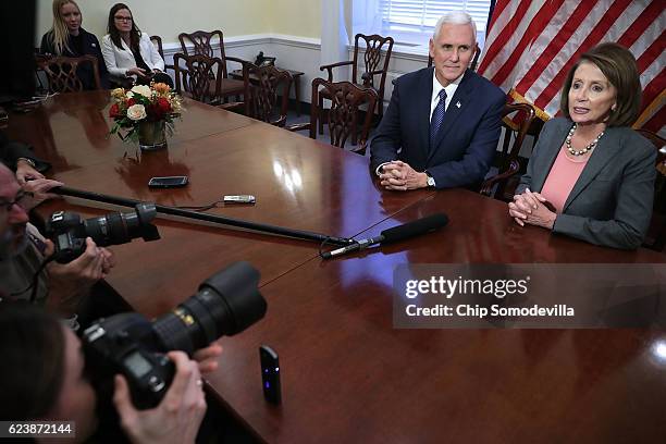 Vice President-elect Mike Pence and House Minority Leader Nancy Pelosi talk to reporters following their meeting in her offices at the U.S. Captiol...
