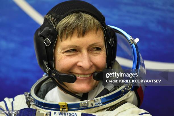 Member of the main crew of the 50/51 expedition to the International Space Station , US astronaut Peggy Whitson looks on in her space suit at the...